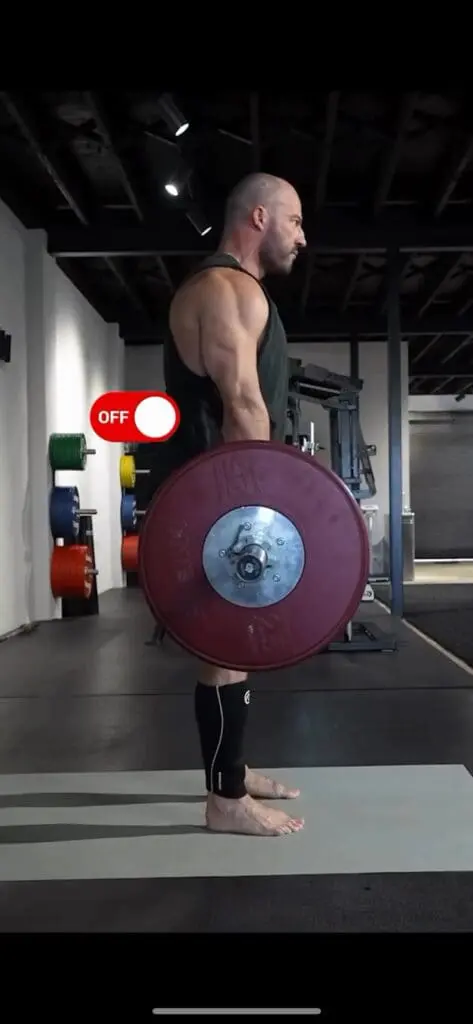 The tension force is converted into a compression force at the waist when the bar is vertical.