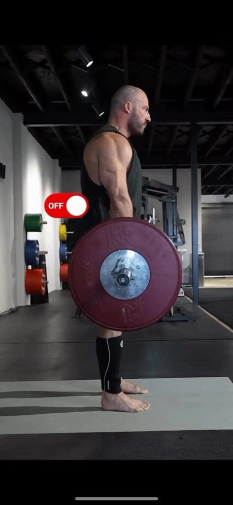 The tension force is converted into a compression force at the waist when the bar is vertical.